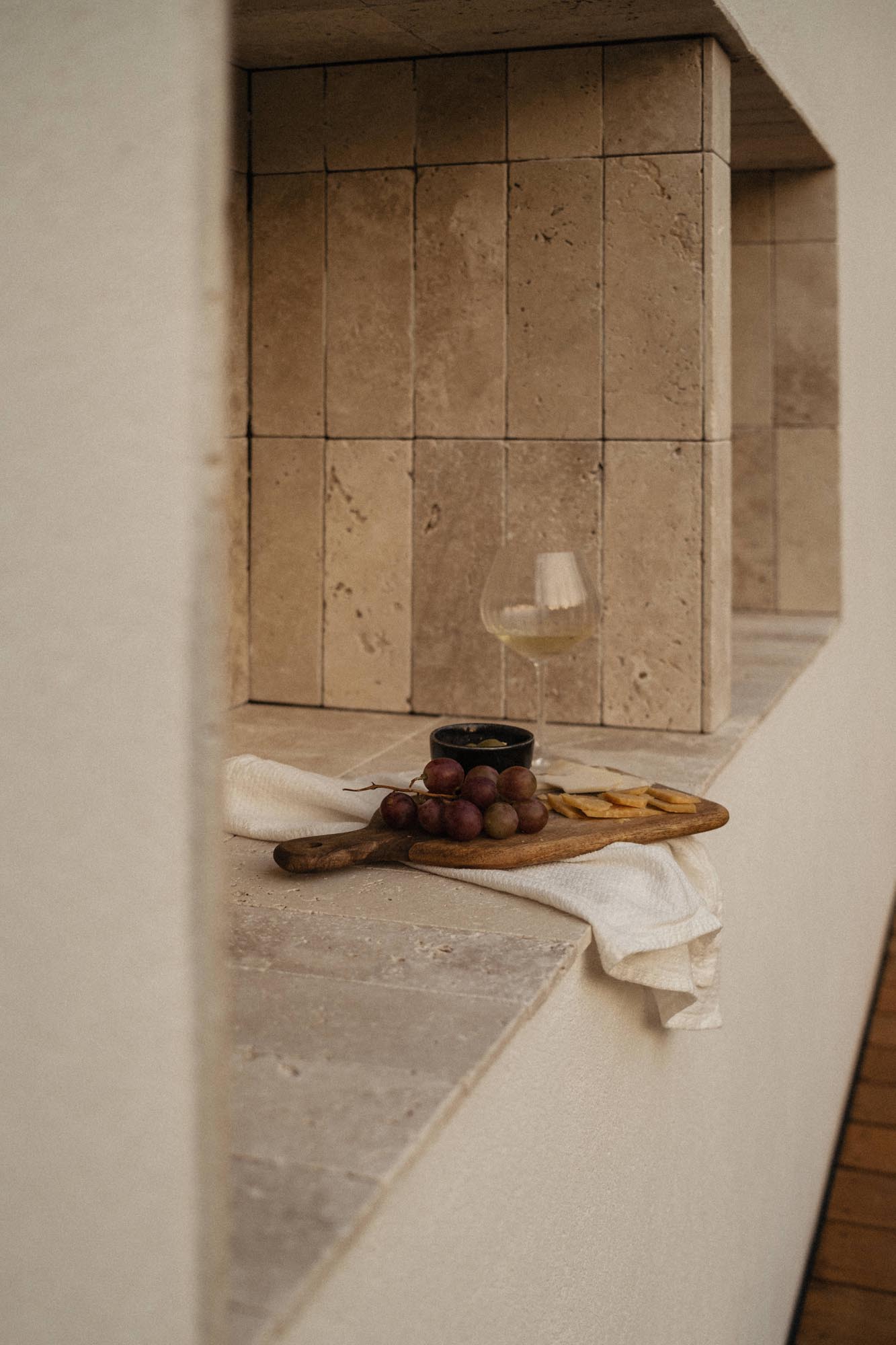 kaboompics elegant cheese and grape platter with a glass of white wine 36352